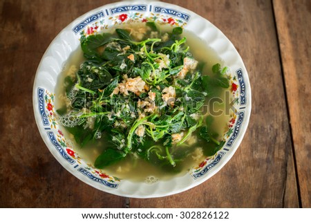 Amaranth vegetables soup with dried shrimp on wooden floor , Vietnam food. canh rau den nau voi tom