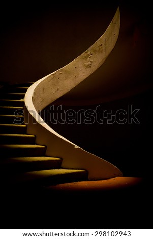 Ruined spiral staircase in dramatic lighting