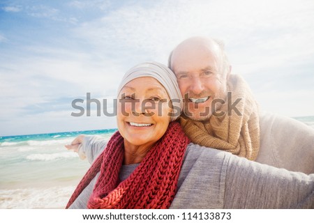 happy senior couple with outstretched arms enjoying retirement flying