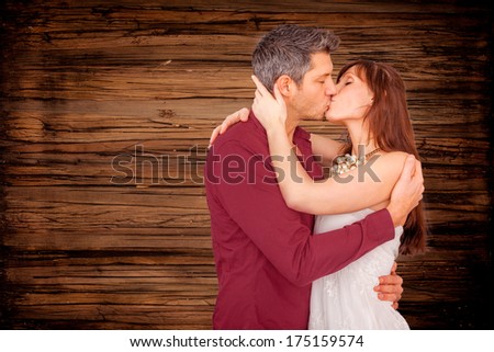 kissing love coule together on wooden background