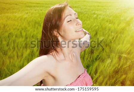 deep breathing ypunger female on sunny day