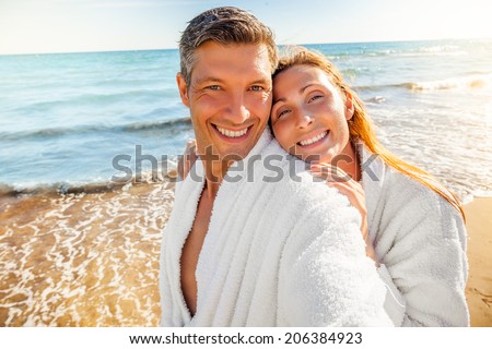 healthy laughing people on tropical wellness spa hotel in bathrobe