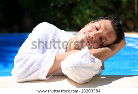 Beauty smiling man dreaming in the pool