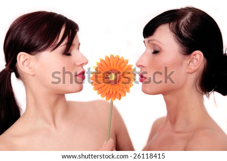 stock photo Two girls kissing a flower