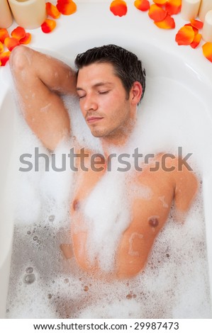 Man relaxing taking a foamy  bath