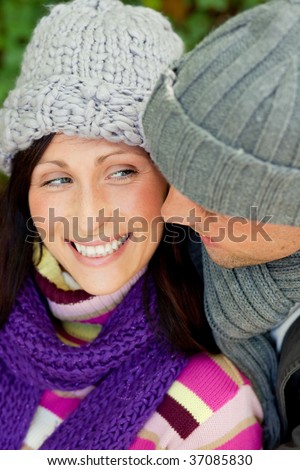 Embracing romantic couple in cold weather time with warm clothes cap and scarf