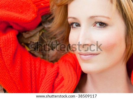 Portrait of wonderful woman lying on forest nature leaf