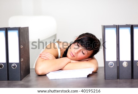 Tired sleeping woman on office desk