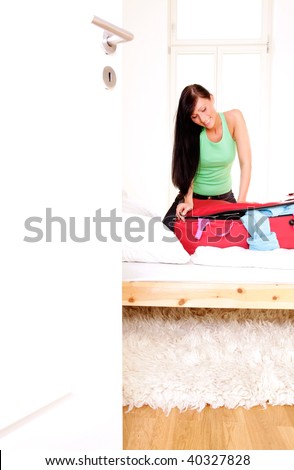 Scenic woman packing clothes in luggage baggage for holiday
