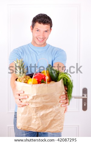 man with supermarket bag after buying healthy healthcare fruits