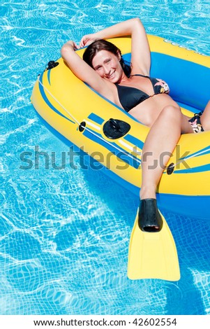 Lilo mattress carefree resting woman floating on blue water in vacation freetime
