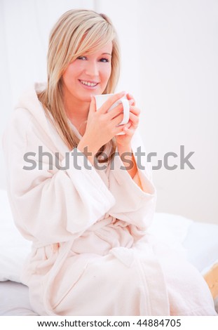 Woman enjoying tranquil serene hot cup at morning time after waking up in hotel suite
