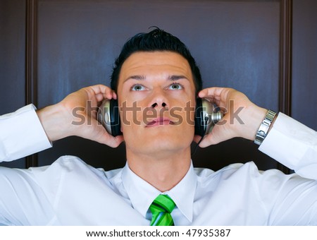 Businessman portrait of young manager listening music
