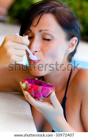 Fruit eating swimming pool relaxing female in in vacation time