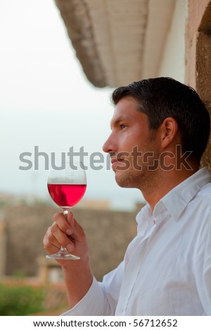 Relaxing man portrait with red wine mediterrean ambience