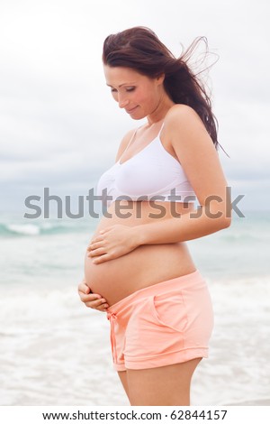 pregnant woman awaiting baby care outdoors as symbol of security and growth