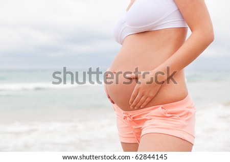pregnant woman awaiting baby care outdoors as symbol of security and growth