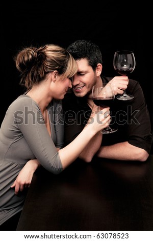 Wine drinking young couple flirting