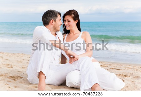 Love couple sitting on the beach