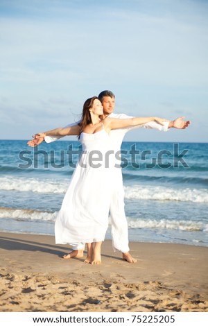 dancing beach couple with arms outstretched