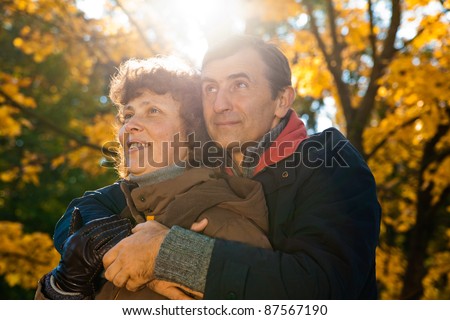 elderly couple enjoying peaceful time on autumn day