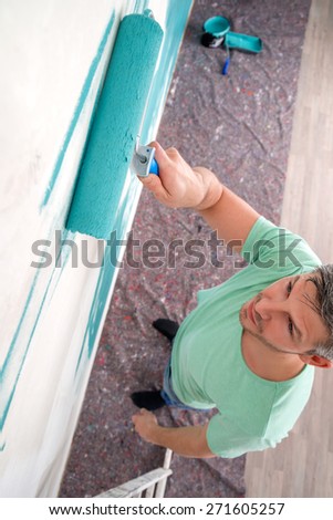 man painting white old wall
