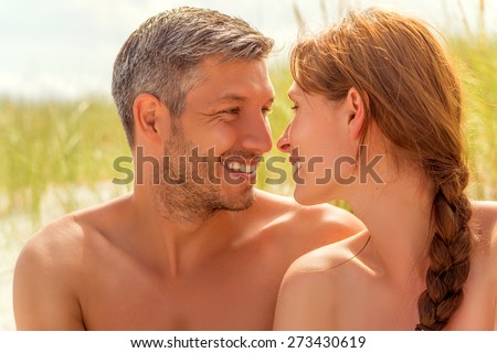 spa couple smiling eachother on dune