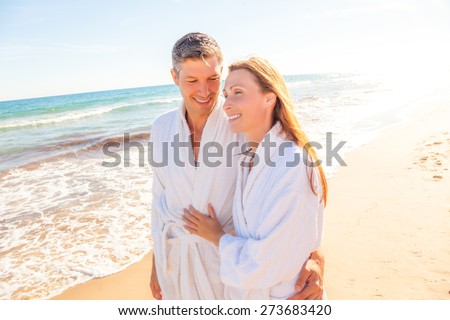 spa couple relaxing while walking beach