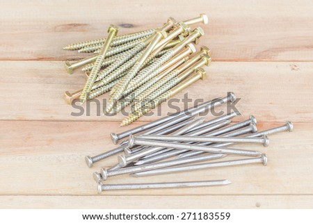 Scattering of steel nails on wooden table