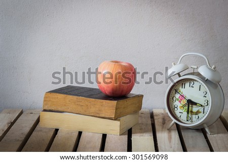 Still Life Apple on Book and clock  on the wooden