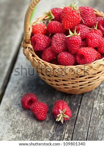 fresh raspberry in a basket on wooden table