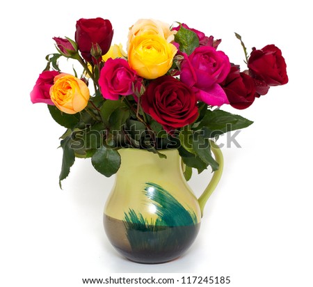 bunch of different roses in a green vase isolated on white