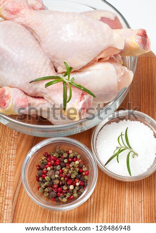 raw chicken legs and spices isolated on cutting board