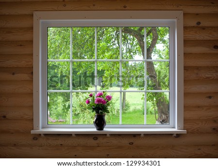 peony flowers on wood log house window-sill
