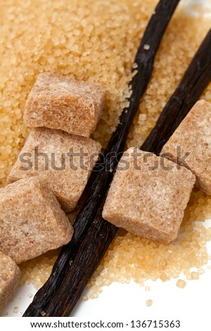vanilla beans and brown vanilla sugar isolated on white background