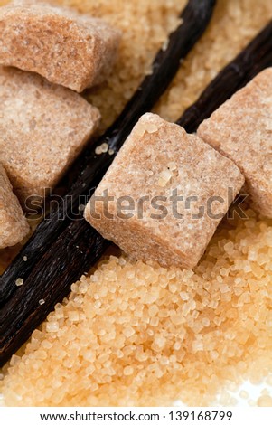 vanilla beans and brown vanilla sugar isolated on white background
