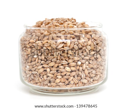 pearl barley in a glass jar isolated on white backrgound
