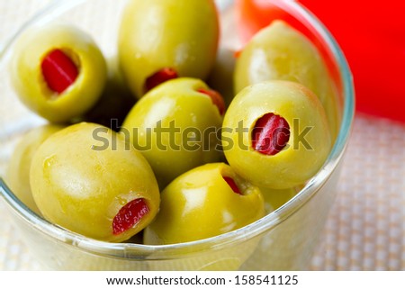 Green olives stuffed with red paprika