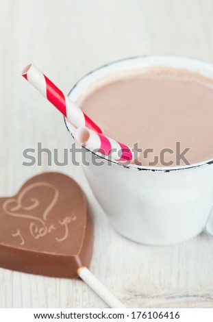 hot chocolate and chocolate heart on wooden surface