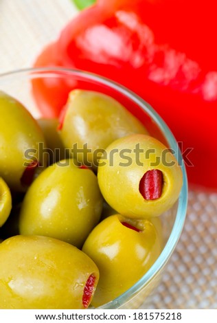Green olives stuffed with red paprika
