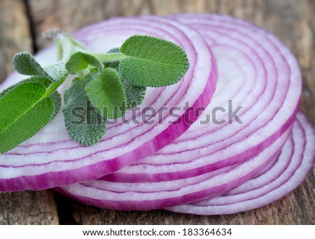 red onion slices on rustic wooden surface
