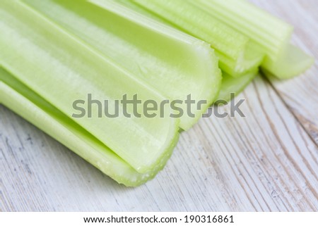 fresh celery sticks on wooden table