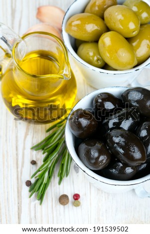 green and black olives on wooden surface