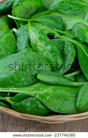 spinach in a basket on wooden surface