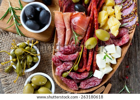 Antipasti and catering platter with different meat and cheese products