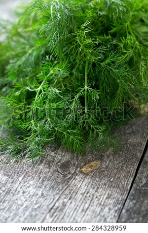 bunch of dill on wooden surface