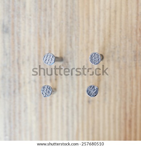 nail head set on wood background