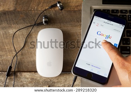 CHIANGMAI, THAILAND -JUNE 16, 2015:A man touch  on screen new Apple iPhone 6 Plus smartphone device open google application.