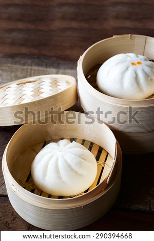 steamed bun in bamboo basket vintage effect,dark food.