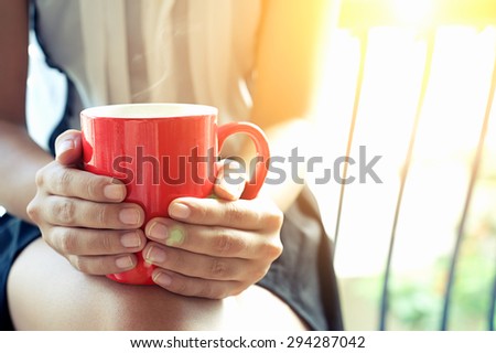 Young woman hands holding coffee mug in the morning day , Vintage Effect